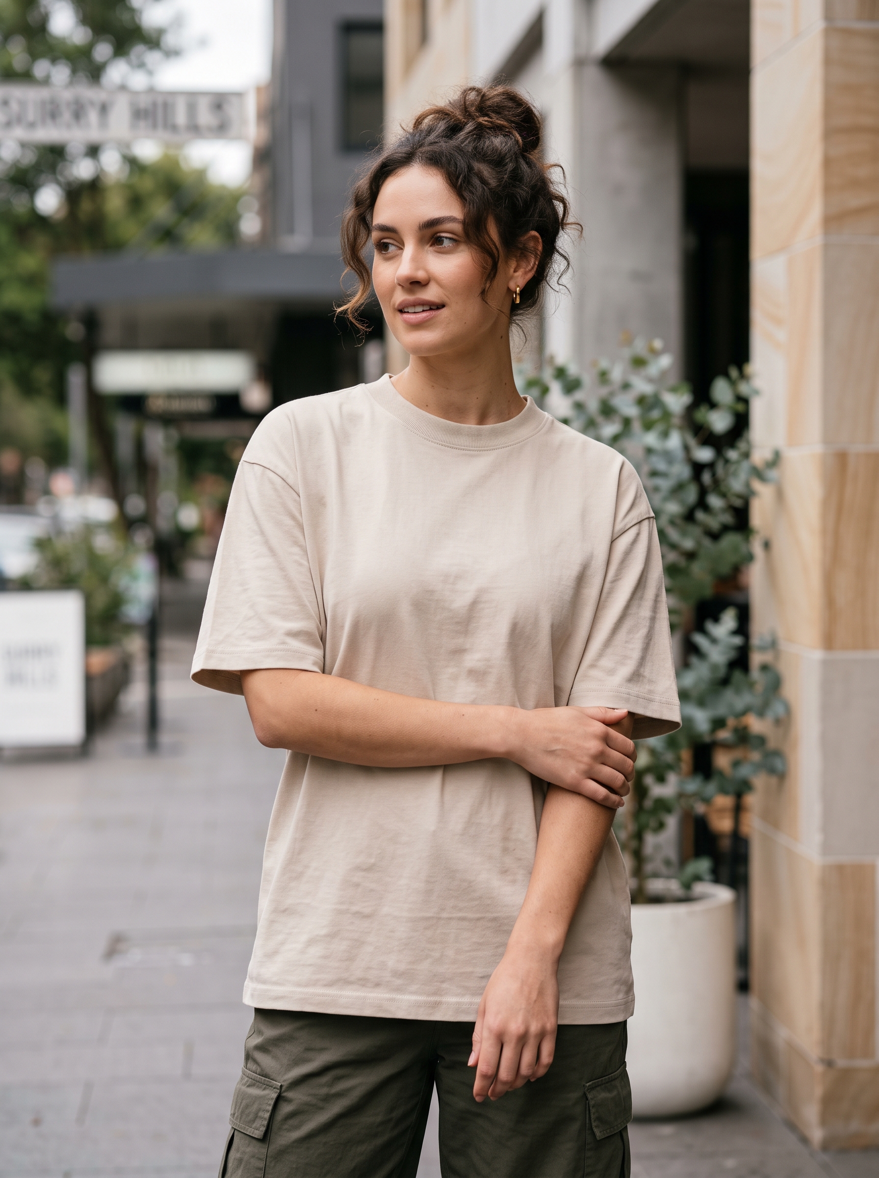 Editorial portrait of an adult female model wearing MAGCOMSEN Women's T Shirts Cotton Short Sleeve Shirts Crew-Neck Summer Tops Classic-Fit Tees Breathable Casual Clothes